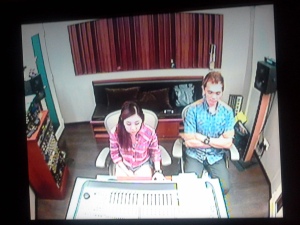 sound engineer Weiqi with Jay at the mixing desk, photo taken from the recording booth